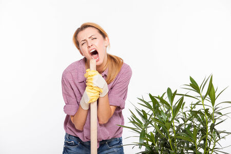 concept of beautiful woman gardening plants and singing, isolated on white backgroundの写真素材
