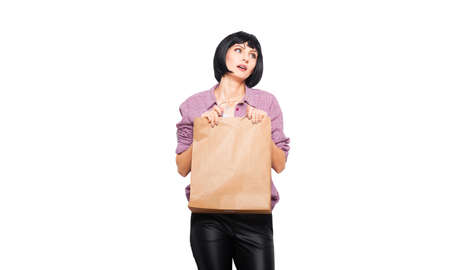 thinking woman with a shopping classic bag, on whiteの写真素材