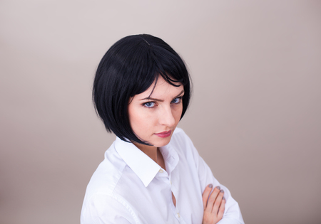 close up of a woman with blue eyes in white office shirtの写真素材