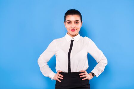 beautiful office woman in white shirt on blue backgroundの写真素材