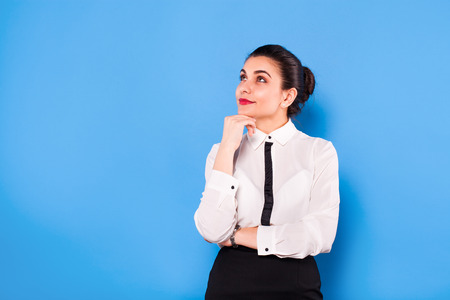 beautiful office woman in white shirt on blue backgroundの写真素材