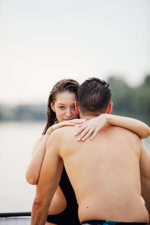 lovers man and woman relaxing in water on a paddleboard and smilingの写真素材
