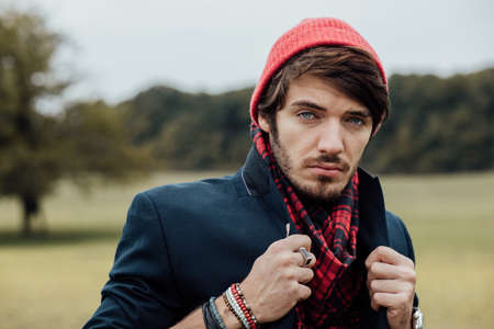cool young man on a country road with field and trees