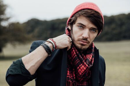 cool young man on a country road with field and treesの写真素材