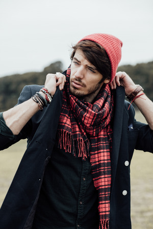 cool young man on a country road with field and treesの写真素材
