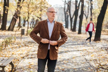 elegant old men walking relaxed in parkの写真素材