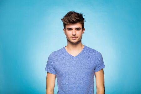 young cute man on standing on blue background