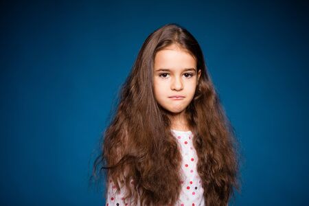 beautiful little girl with curls, being sad