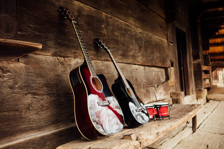 guitar leaning on a old wooden porchの写真素材