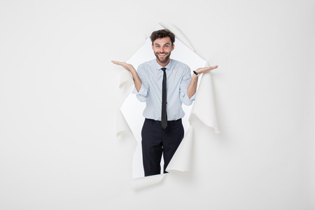 young office man with tie and breaking the paper background, presenting the backgroundの写真素材