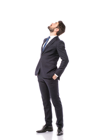 corporate man, elegant businessman standing on white background pointing and looking upの写真素材