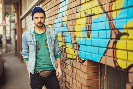 young and super cool hipster guy walking on the street, vintage lifestyleの写真素材