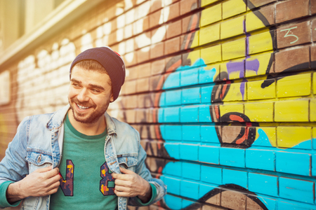 clouse up of a cool guy with colored hat on the street, lifestyle pictureの写真素材