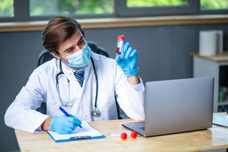 happy smiling doctor showing ok sign, excited about his discovery, he find a cure about a general illness, or giving a good news about a blood testの写真素材