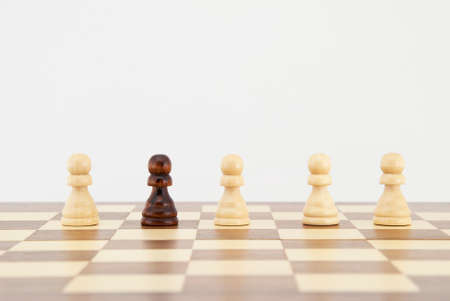 Chess pawn on chessboard with white background. Landscape format.
