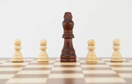 Chess king and pawns on chessboard with white background  Landscape format の写真素材