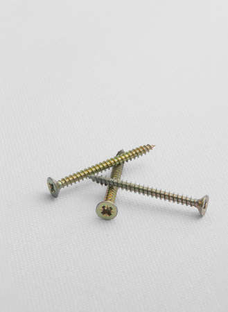 Closeup of bolts on white canvas backgroundの写真素材