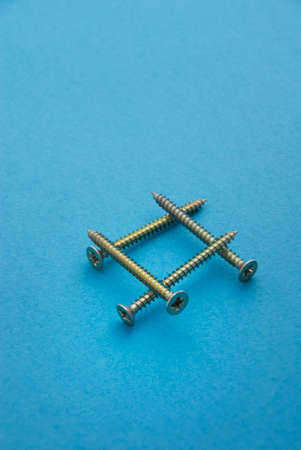 Chipboard Screws on light blue background. の写真素材