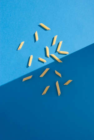 Penne Rigate Pasta on light blue backgroundの写真素材