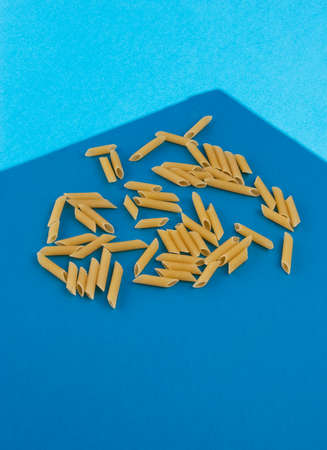 Penne Rigate Pasta on light blue backgroundの写真素材