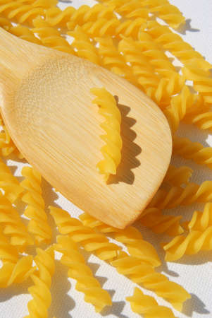 Rotini Pasta and wooden spoon. High Angle view.の写真素材