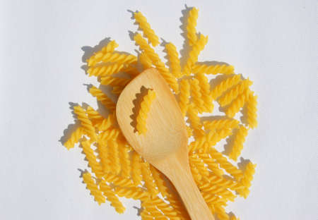 Rotini Pasta and wooden spoon. Above view.の写真素材
