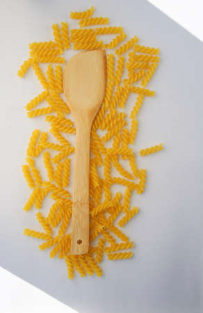 Rotini Pasta and wooden spoon. Above view.の写真素材