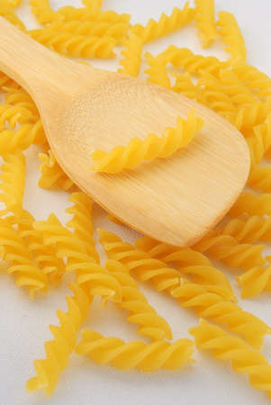 Rotini Pasta and wooden spoon.の写真素材