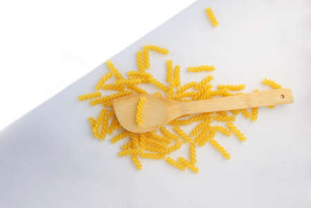 Rotini Pasta and wooden spoon. Above view.の写真素材