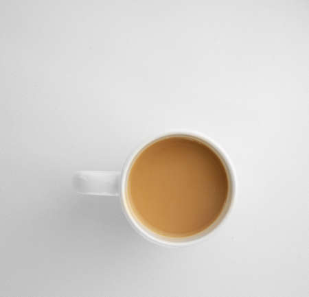 coffee mug with cappuccino on light grey background. Mimimalistic studio shoot. Above viewの写真素材