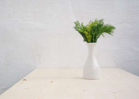 Fresh dill in flowerpot on wood texture backgroundの写真素材