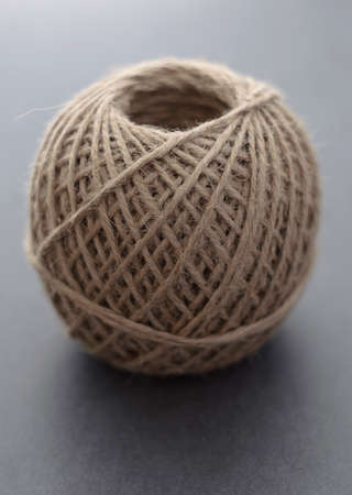 Roll of twine on dark background. Shallow depth of field.