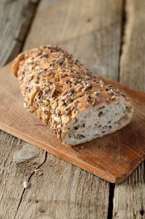 Whole grain bread on wood table. Shallow depth of field.