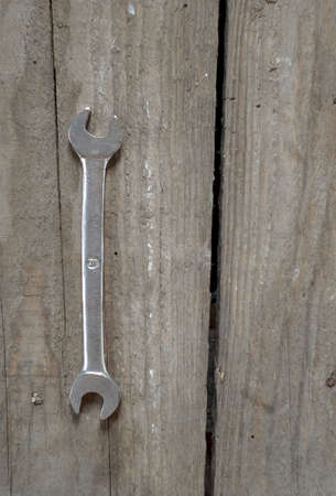 Rusty hand wrench tool on old wood background. Above view.の写真素材