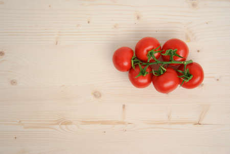 Tomatoes on wood background. Aboce view.の写真素材