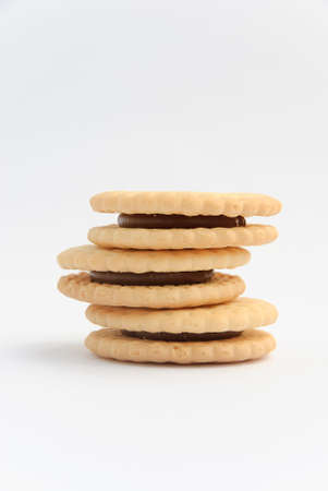 Chocolate cream filled cookies on white backgroundの写真素材