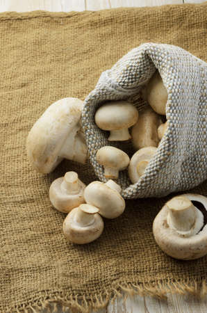 Champignon mushrooms in natural canvas bag.の写真素材