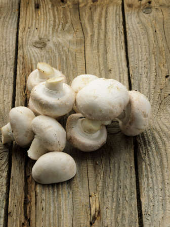 Champignon mushrooms on wood backgroundの写真素材