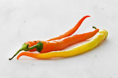 Red peppers on light wooden backgroundの写真素材