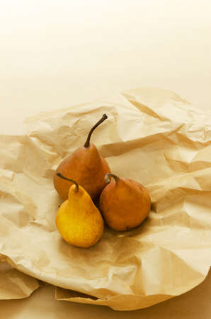 Three ripe pears over brown paper background with copy space (negative space)の写真素材