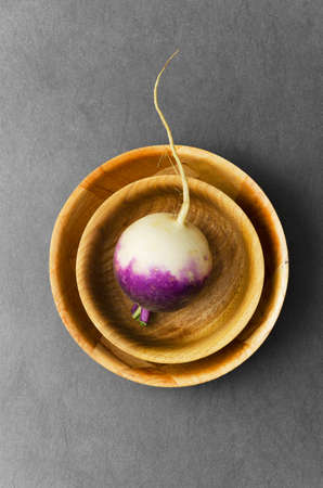 Organic turnip in round bowls over dark background