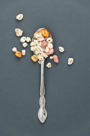 Cereal in a old spoon over dark grey backgroundの写真素材