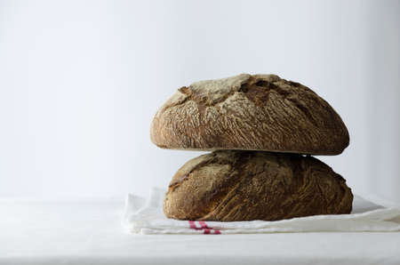 Traditional round bread over white cloth table