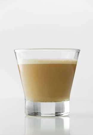 Cappuccino in a transparent cup over white tableの写真素材