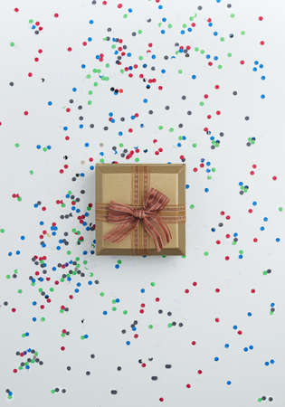 Gift box with confetti over white tableの写真素材