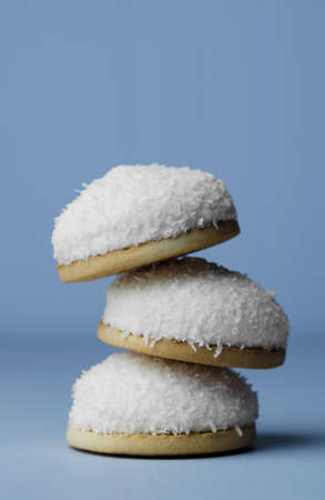 Marshamallow biscuits with coconut sprinkles over blue backgroundの写真素材