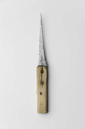 Old damaged knife with wooden handle over white background, top viewの写真素材