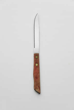 Silver knife with wooden handle over white background, top viewの写真素材