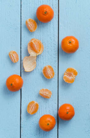 Multiple clementines over blue wooden table, top viewの写真素材