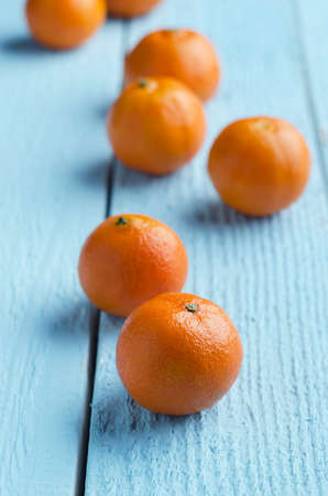 Multiple clementines over blue wooden tableの写真素材